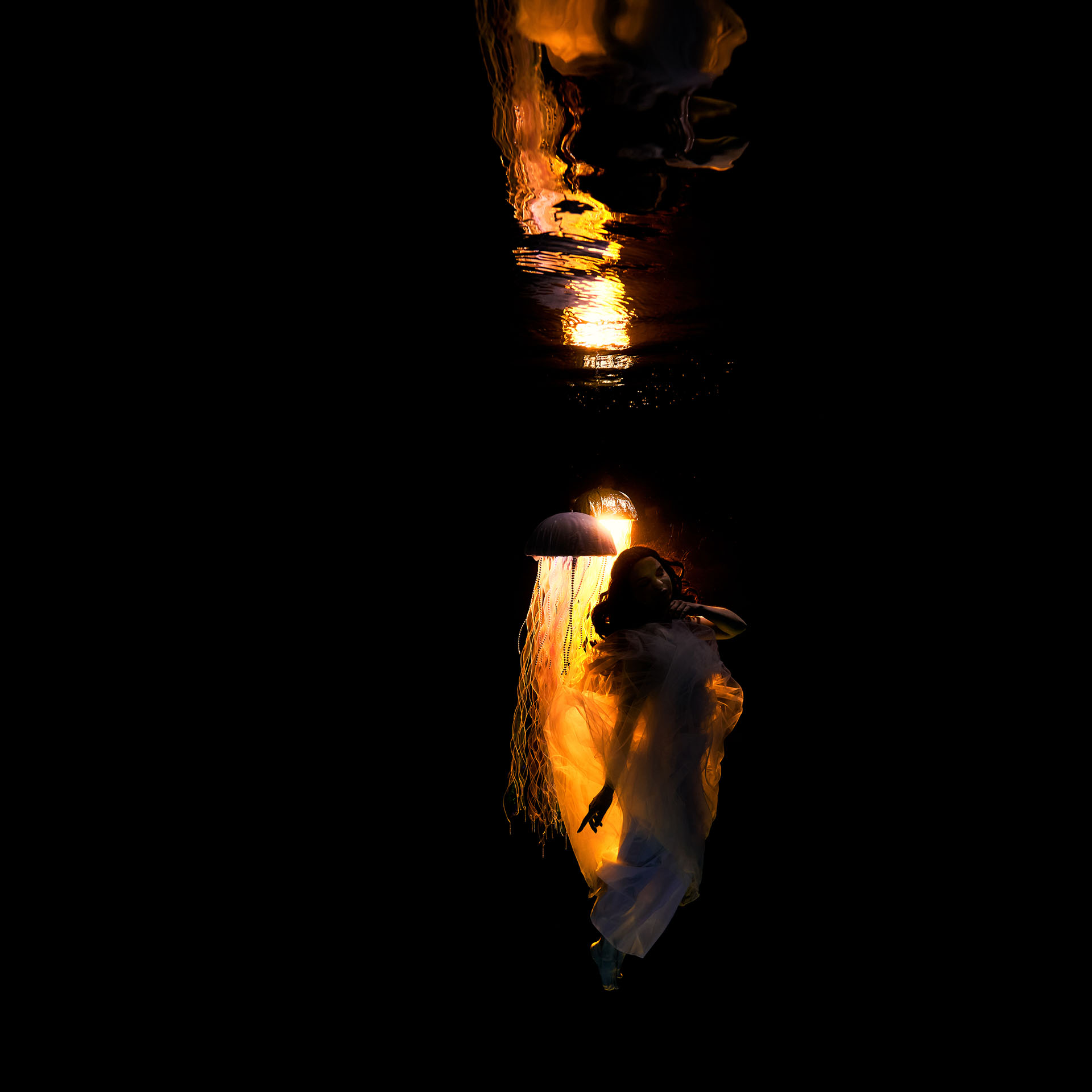 Eclipse — a figure suspended in weightlessness underwater among glowing LumiJellys, TheLumiVerse by Stephan Ernst